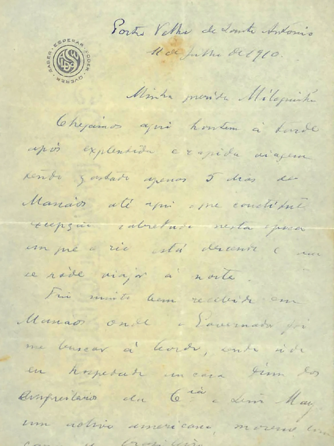 Carta manuscrita de Oswaldo à Miloquinha, escrita à tinta azul em papel amarelado e com manchas do tempo. Na primeira página, no canto superior esquerdo, há um carimbo preto circular com as letras do nome Oswaldo estilizadas. Em volta do carimbo, as palavras “Esperar”, “Poder”, “Querer” e “Saber” formam um círculo. No cabeçalho, está escrito: “Porto Velho de Santo Antônio, 11 de julho de 1910”. Para conhecer o conteúdo das quatro páginas da carta, leia as cartas pessoais de Oswaldo.